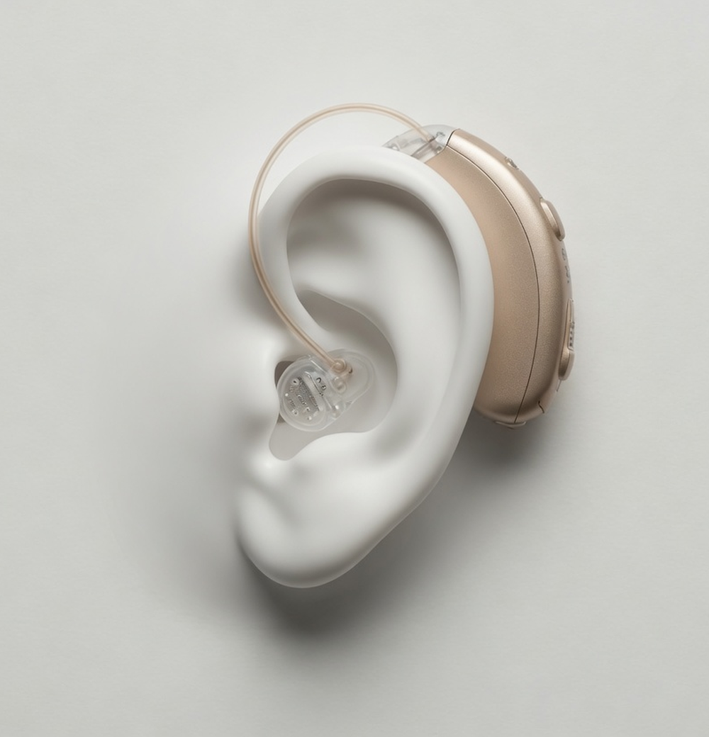 A white studio model of an ear wearing a hearing aid
